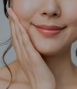 smiling woman touching her face