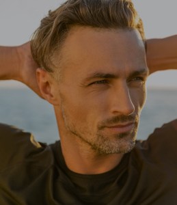 man with his hands behind his head